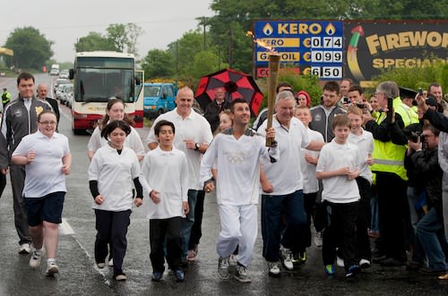 Wayne McCullough carries the Olympic Flame up to the Border. Picture: Mark Pearce